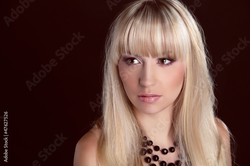 Portrait of young beautiful woman with blond glossy hair. Beauty