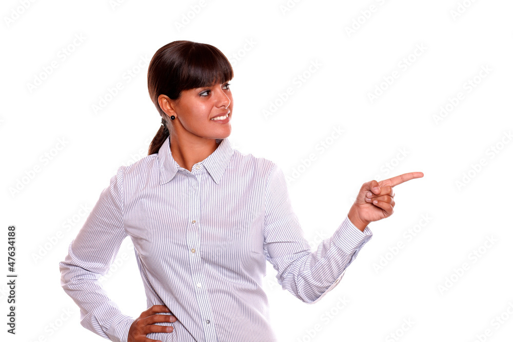 Smiling young woman looking and pointing left Smiling young woman looking and pointing left