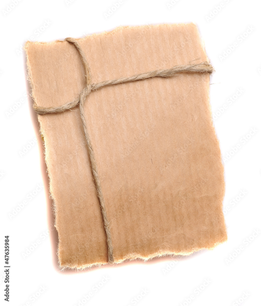String tied in a bow on a brown recycled paper String tied in a bow on a brown recycled paper