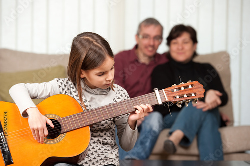 little girl playing guitar