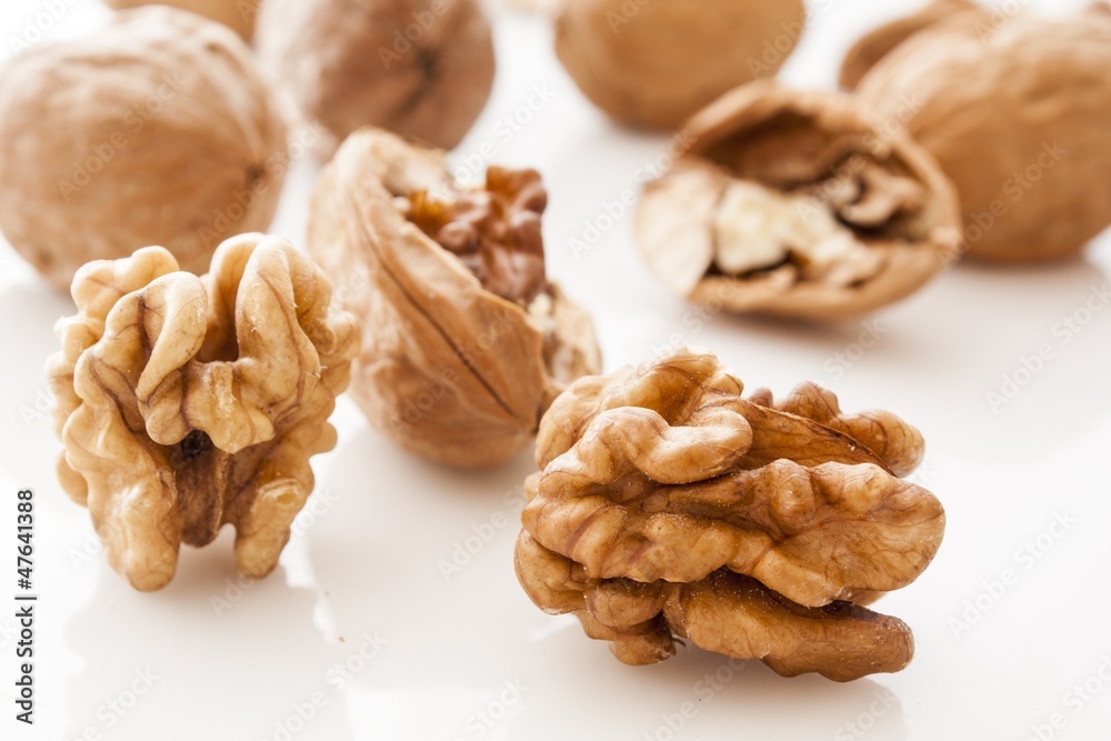 walnut and a cracked walnut on white background walnut and a cracked walnut on white background