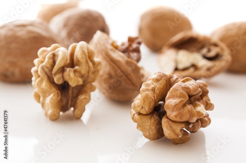 walnut and a cracked walnut on white background