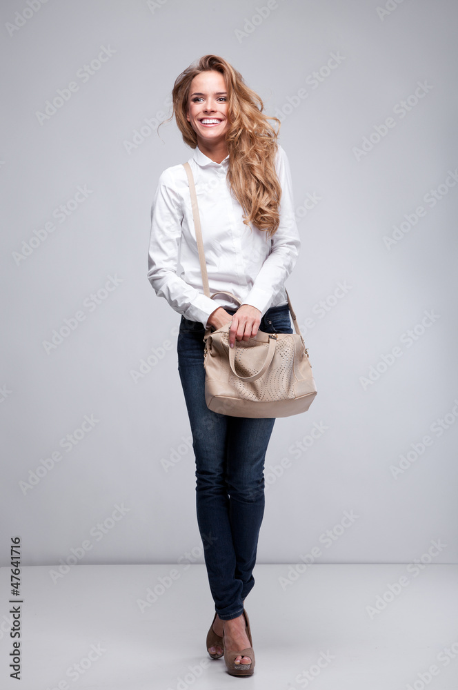 Beautiful woman holding a handbag Beautiful woman holding a handbag