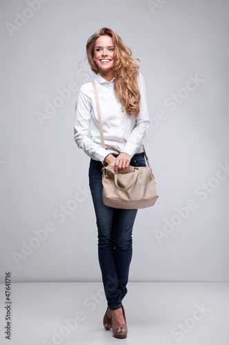Beautiful woman holding a handbag 