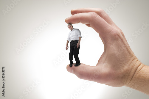 Concept picture of studio man between fingers