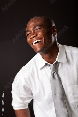 laughing african american man over black background