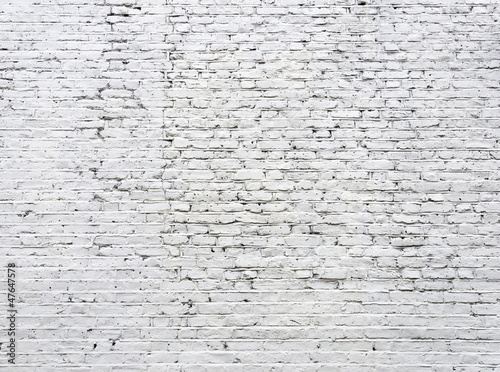 Cracked white brick wall