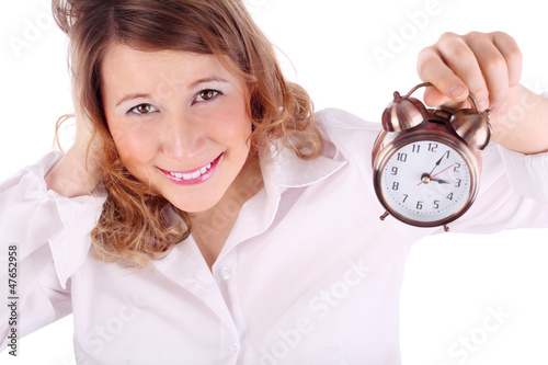 Awakening woman in white holds alarm clock isolated on white