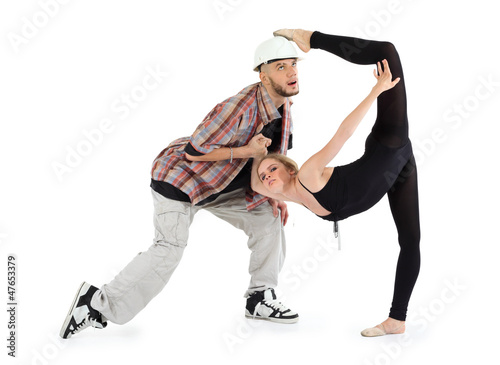 Ballerina in black put her foot on head of man and breakdancer