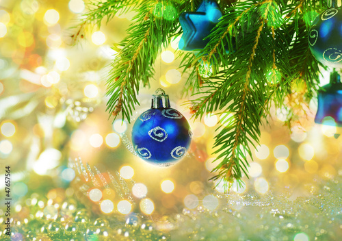 Greeting card with christmas balls on branch of fir tree on mult