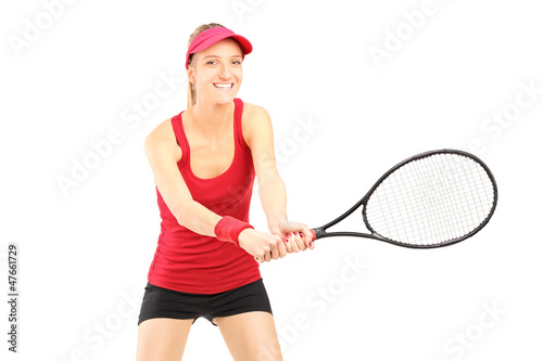 A young female playing tennis