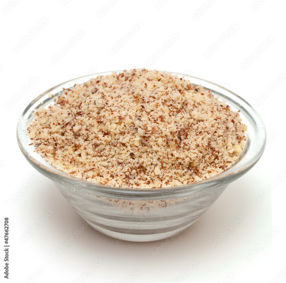 grated almond in a bowl isolated on white background grated almond in a bowl isolated on white background
