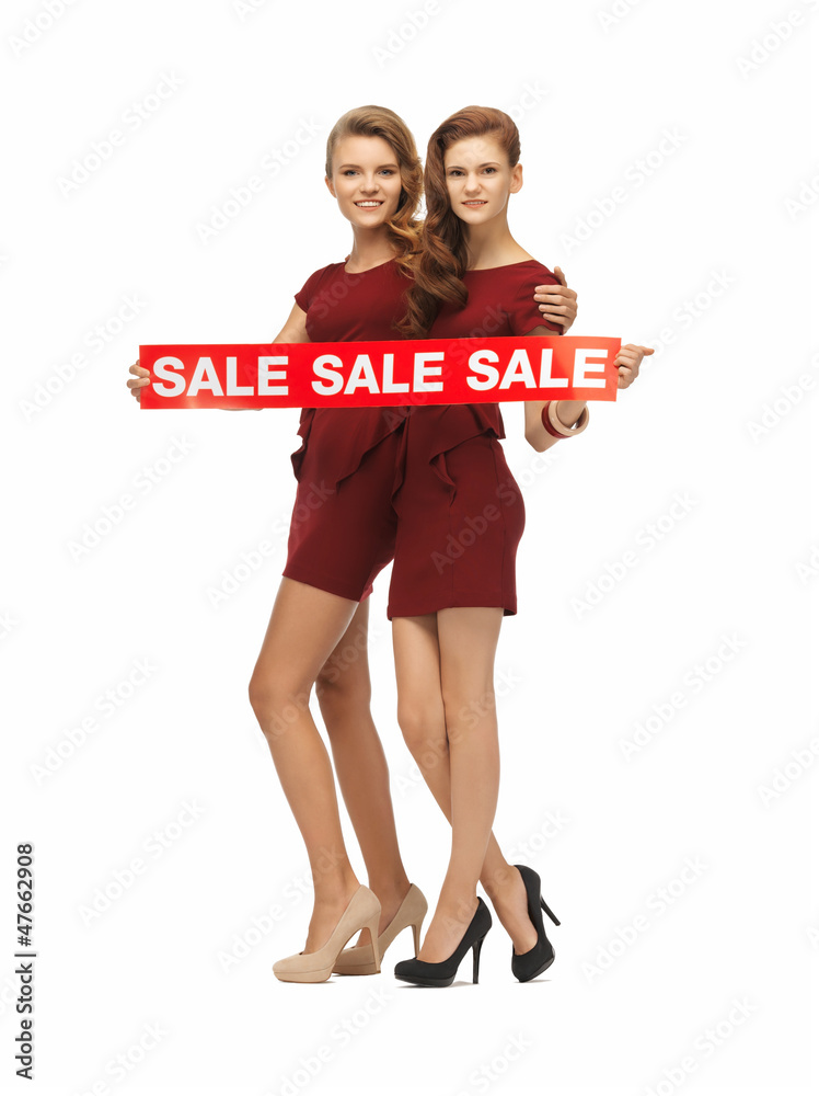 Fototapeta premium teenage girsl in red dresses with sale sign