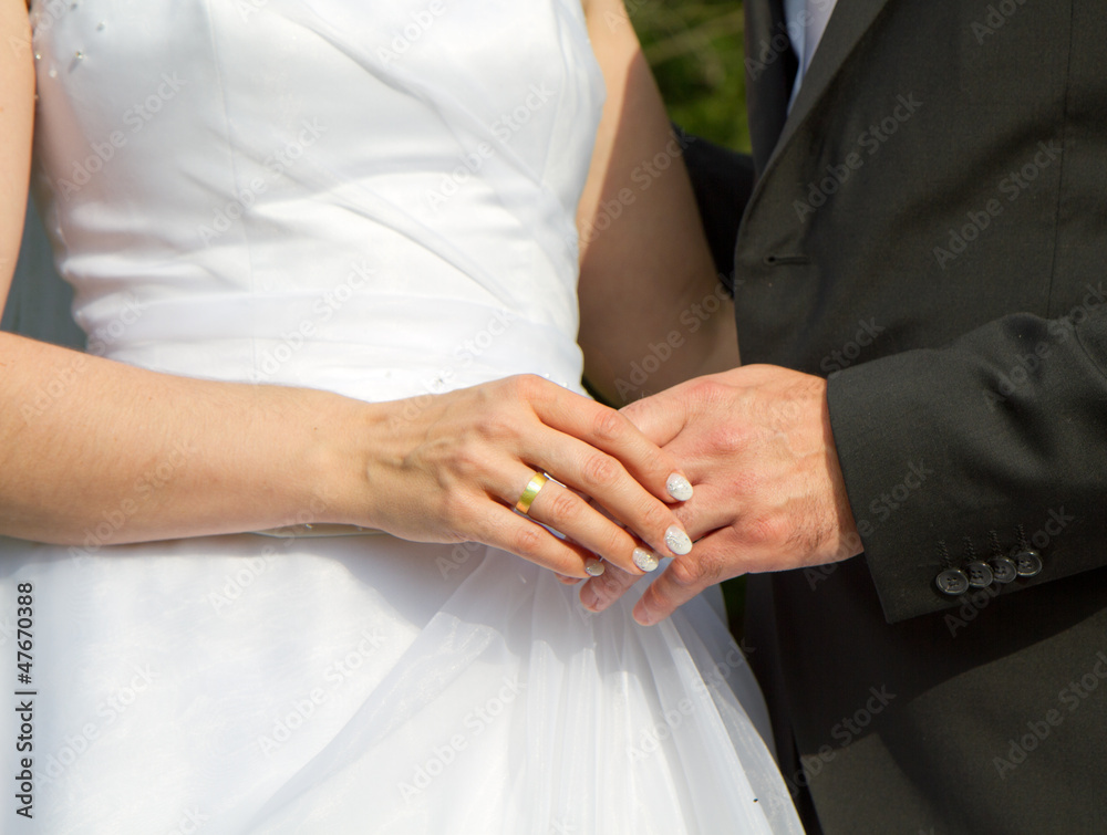 bride and groom holding hands after wedding show there rings