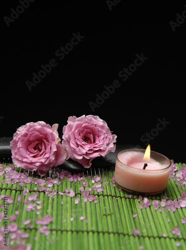 Two rose with candle on green mat