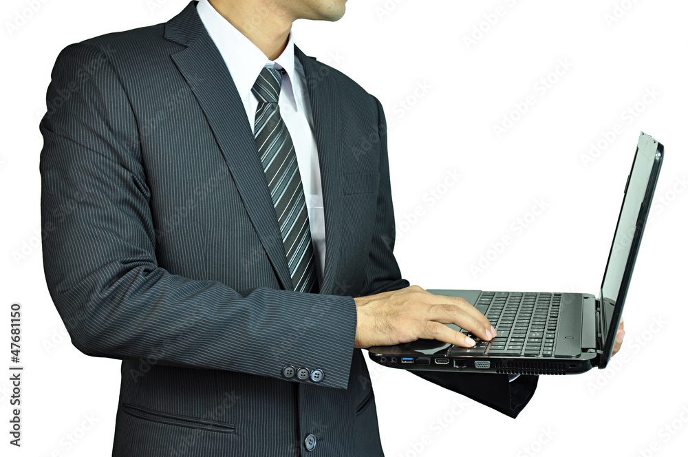 Businessman holding and typing laptop computer Businessman holding and typing laptop computer