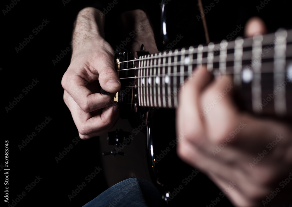 Fototapeta premium Human hand playing an electric guitar