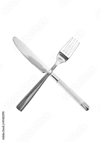 Crossed knife and fork on a white background