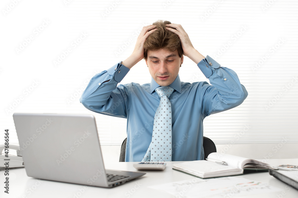 Young businessman having a problems at the office Young businessman having a problems at the office
