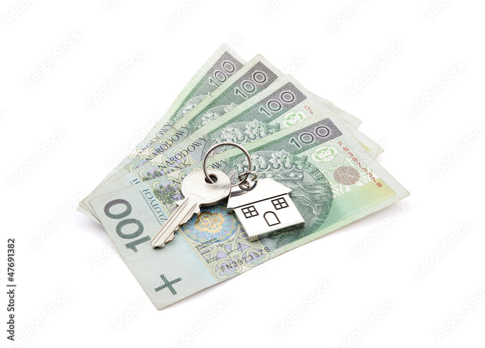 House key on pile of polish banknotes with clipping path House key on pile of polish banknotes with clipping path