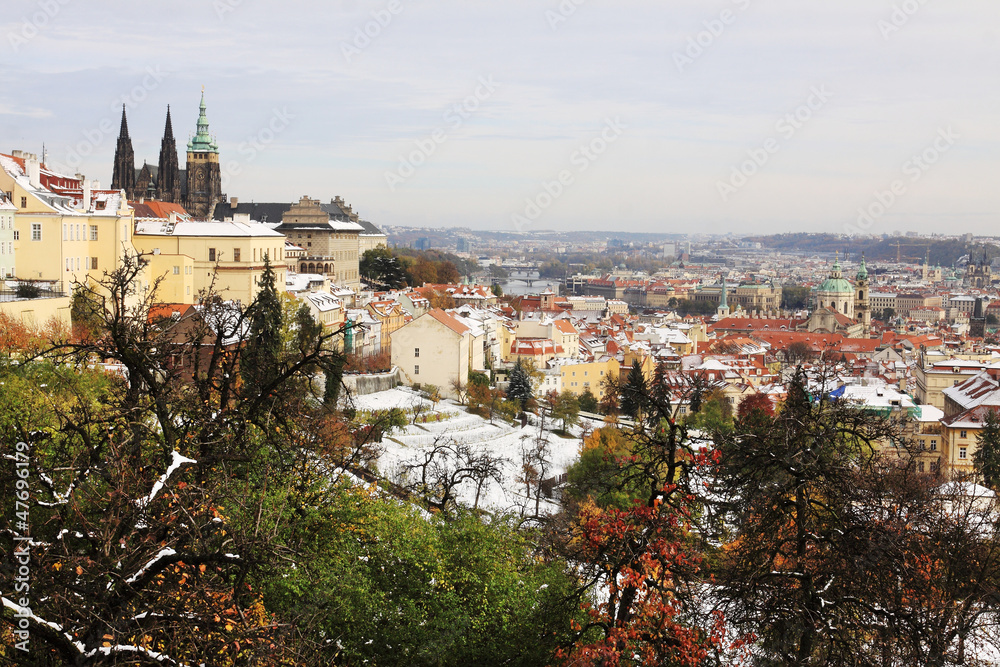Snowy colorful autumn Prague with gothic Castle, Czech Republic