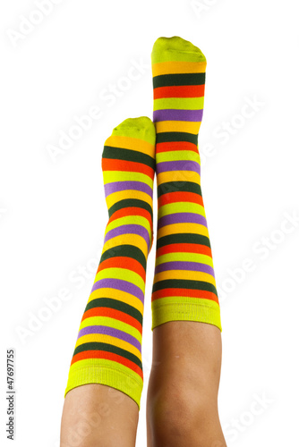 female legs in colorful striped socks isolated