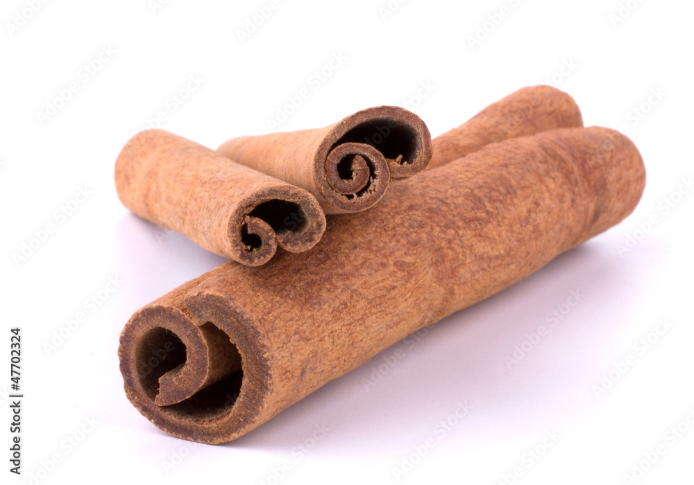 Cinnamon sticks stacked on white background Cinnamon sticks stacked on white background