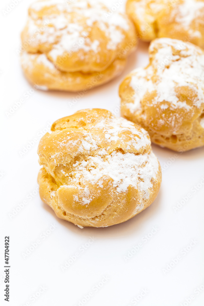 Cream puffs sprinkled with powdered sugar