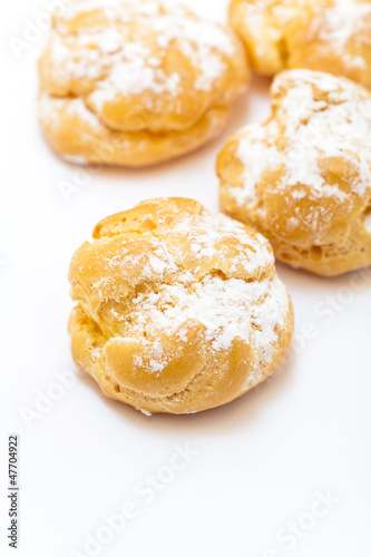 Cream puffs sprinkled with powdered sugar