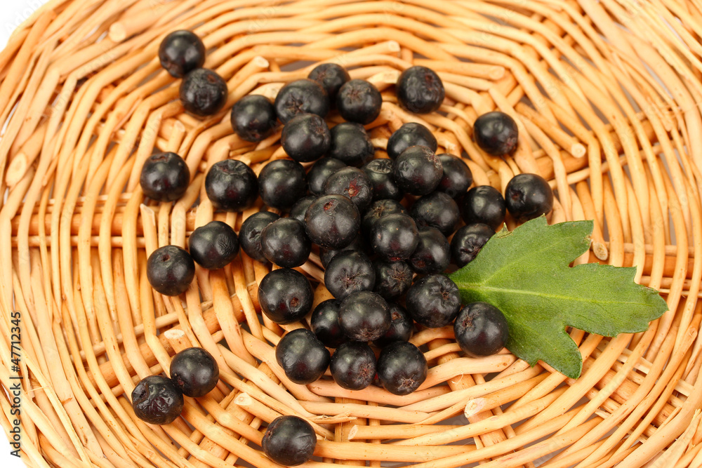 chokeberry with green leaf on wicker mat close-up chokeberry with green leaf on wicker mat close-up