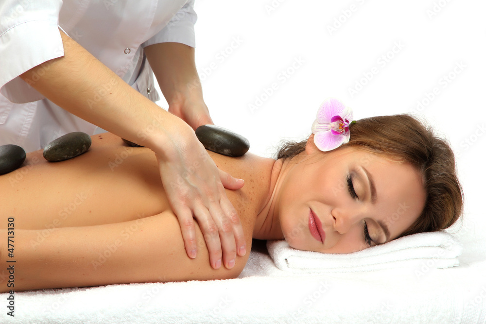 Obraz premium beautiful woman in spa salon with spa stones getting massage,