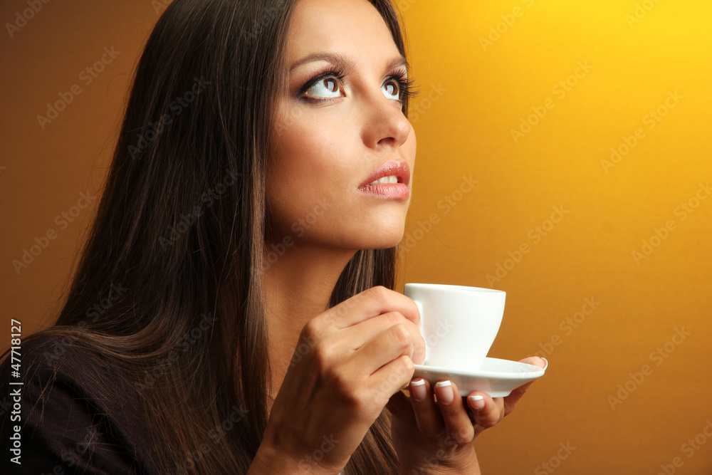 beautiful young woman with cup of coffee, on yellow background beautiful young woman with cup of coffee, on yellow background