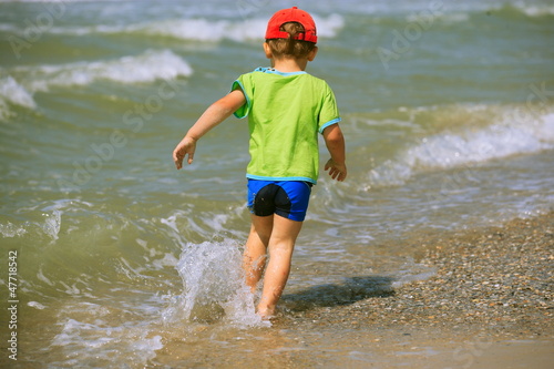 Fototapeta Naklejka Na Ścianę i Meble -  Boy running on  beach
