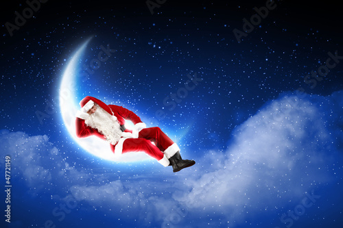 photo of santa claus sitting on the moon