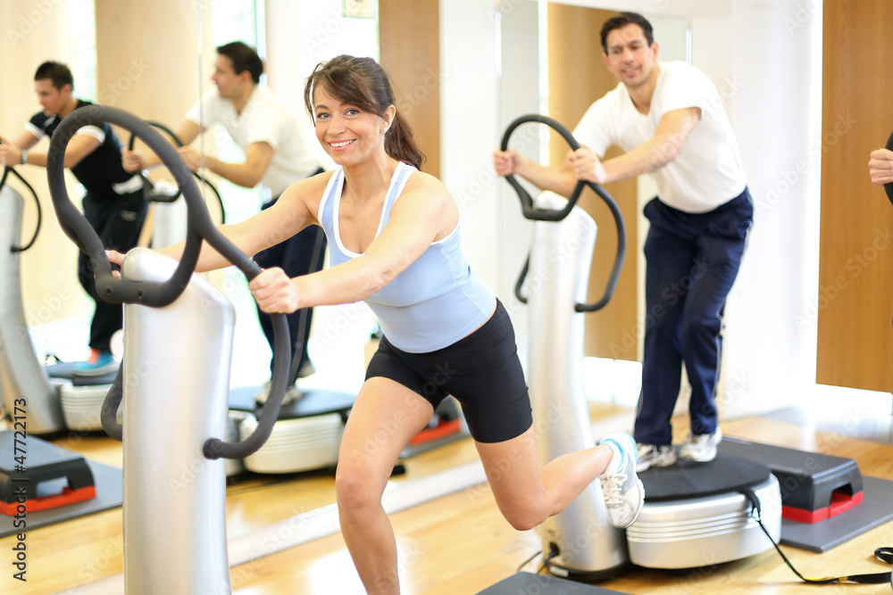 Woman on vibration plate in a gym Woman on vibration plate in a gym