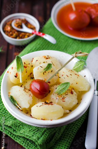 Potatoes boiled with spices and pickled tomatoes
