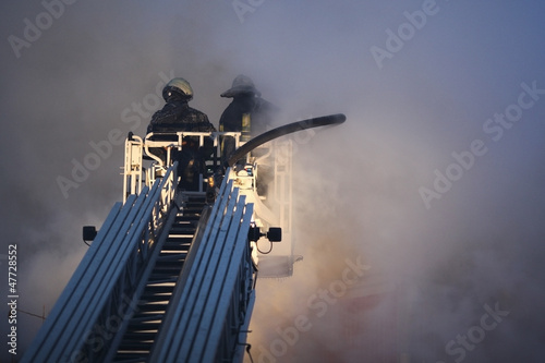 a huge fire with firefighters in action