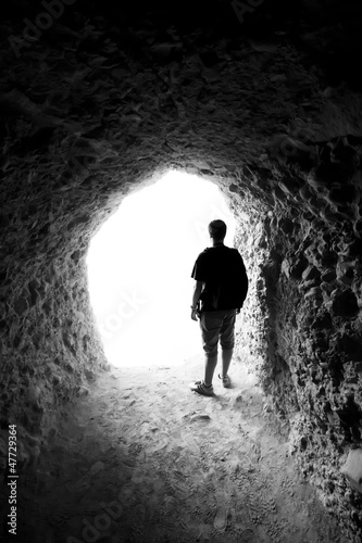 Man in a cave. Light at End of Tunnel