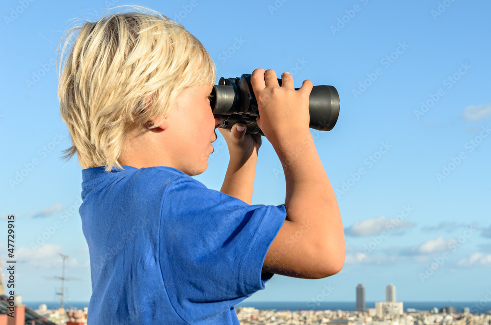 city watch - blonde boy overlooking city with binoculars