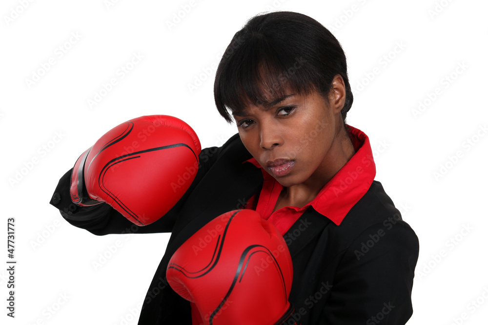 Female office worker wearing boxing gloves Female office worker wearing boxing gloves
