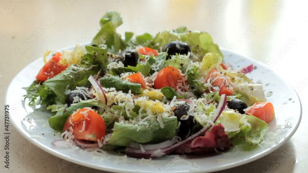 Pour olive oil over the salad - slow motion Pour olive oil over the salad - slow motion