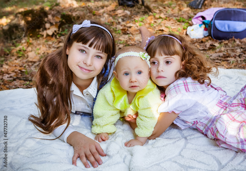 Fototapeta premium Happy little sisters in park