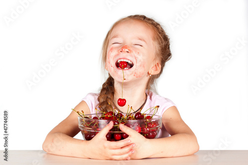 A child with a bowl fresh cherry