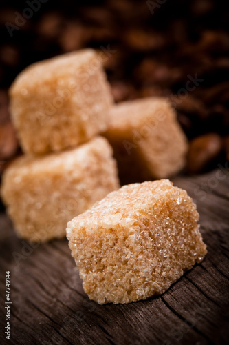 Macro shot of brown sugar on wooden surface © Jag_cz