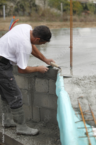 Builder laying foundations