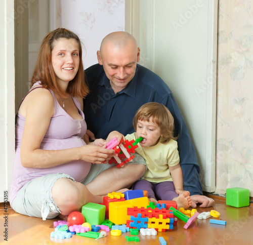 Happy parents and child in home