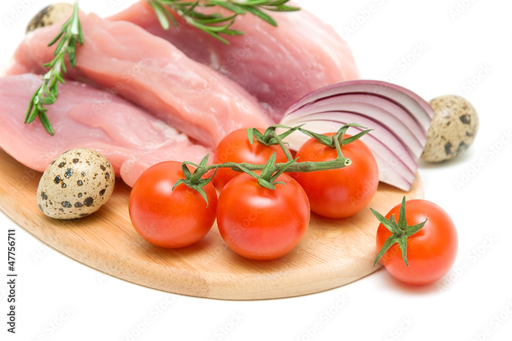 cherry tomatoes, raw meat, eggs, onions and a sprig of rosemary