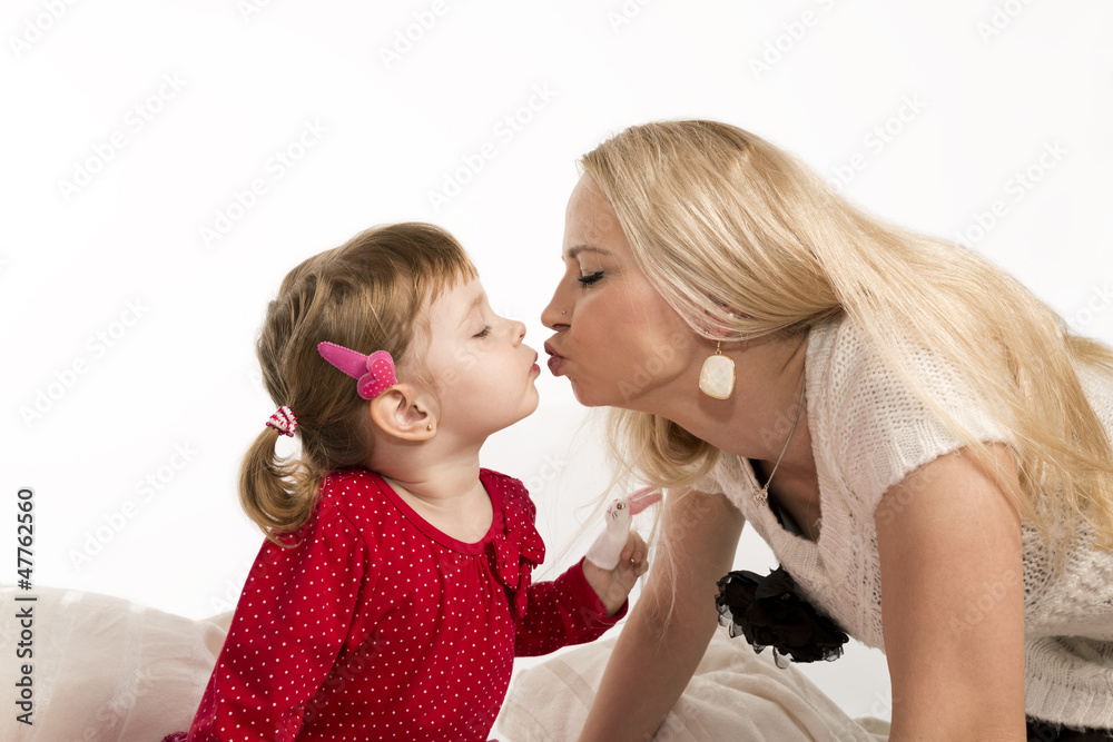 Mother kisses daughter