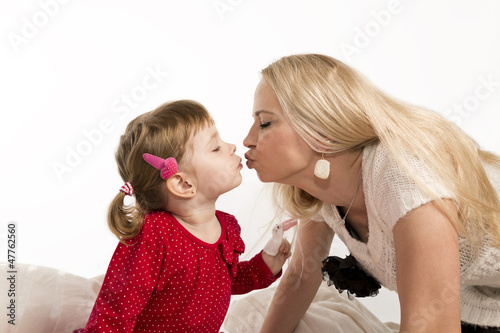 Mother kisses daughter