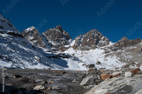 Renjo pass: mountain peaks and stream in Himalayas